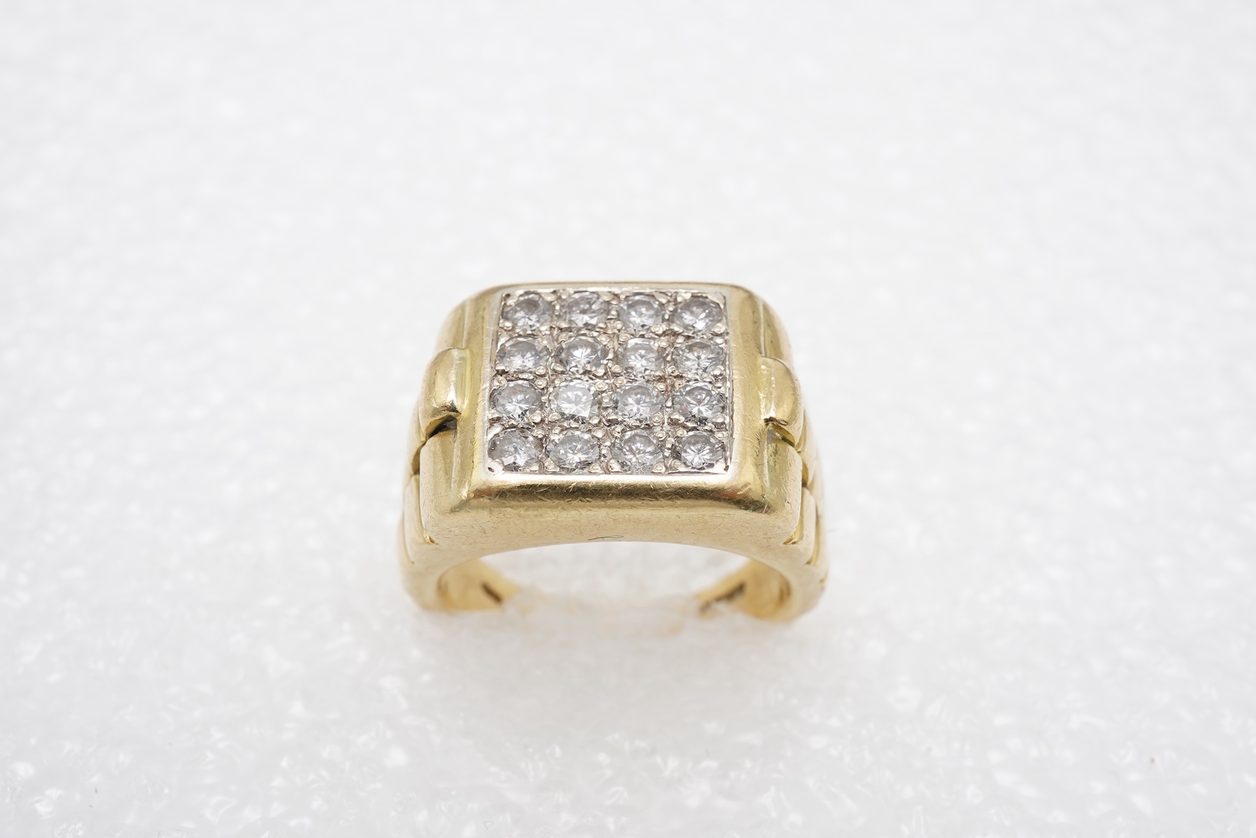 A gold and diamond signet ring